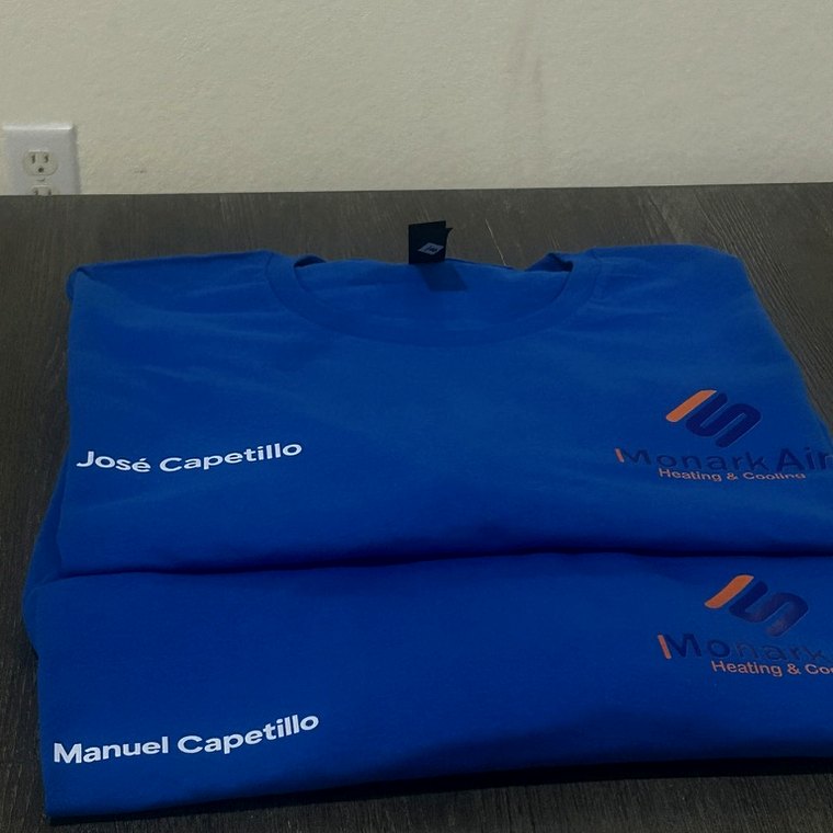 Branded blue polos with company logo, folded and packed